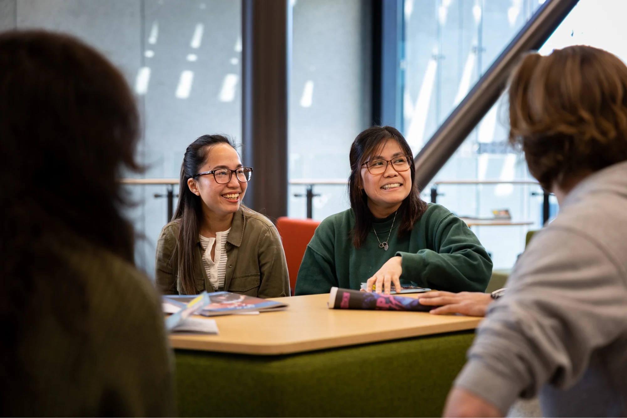 students-sitting-at-table-smiling