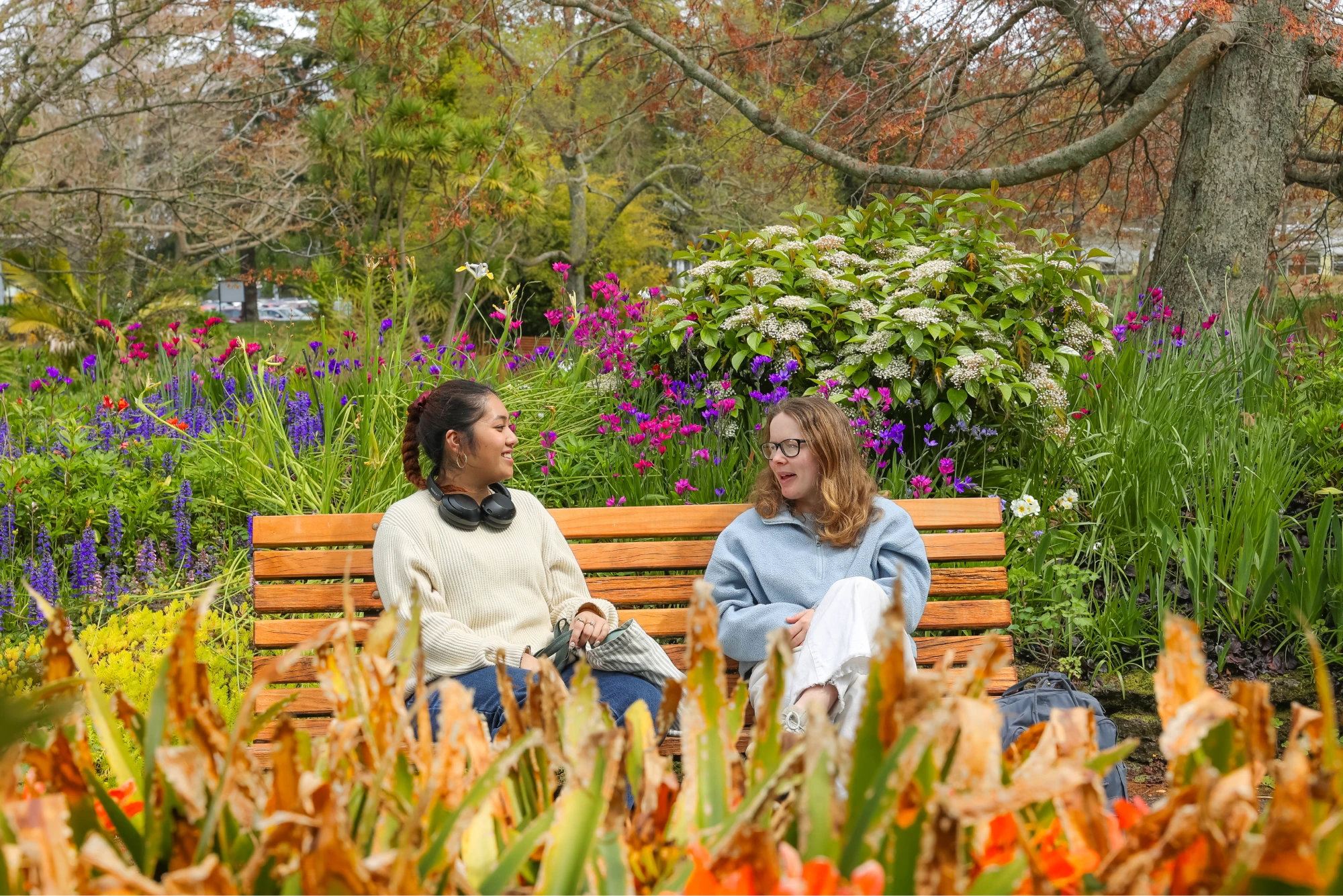 two-students-sitting-outside-sunny