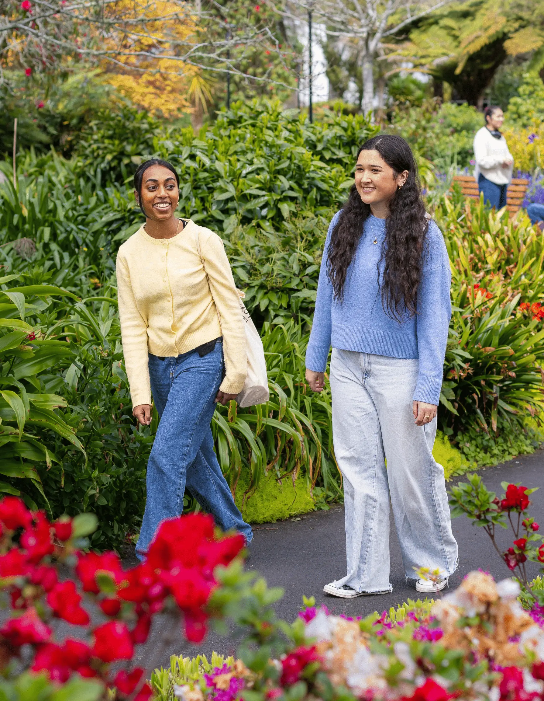 two-students-walking-through-flowers-mobile