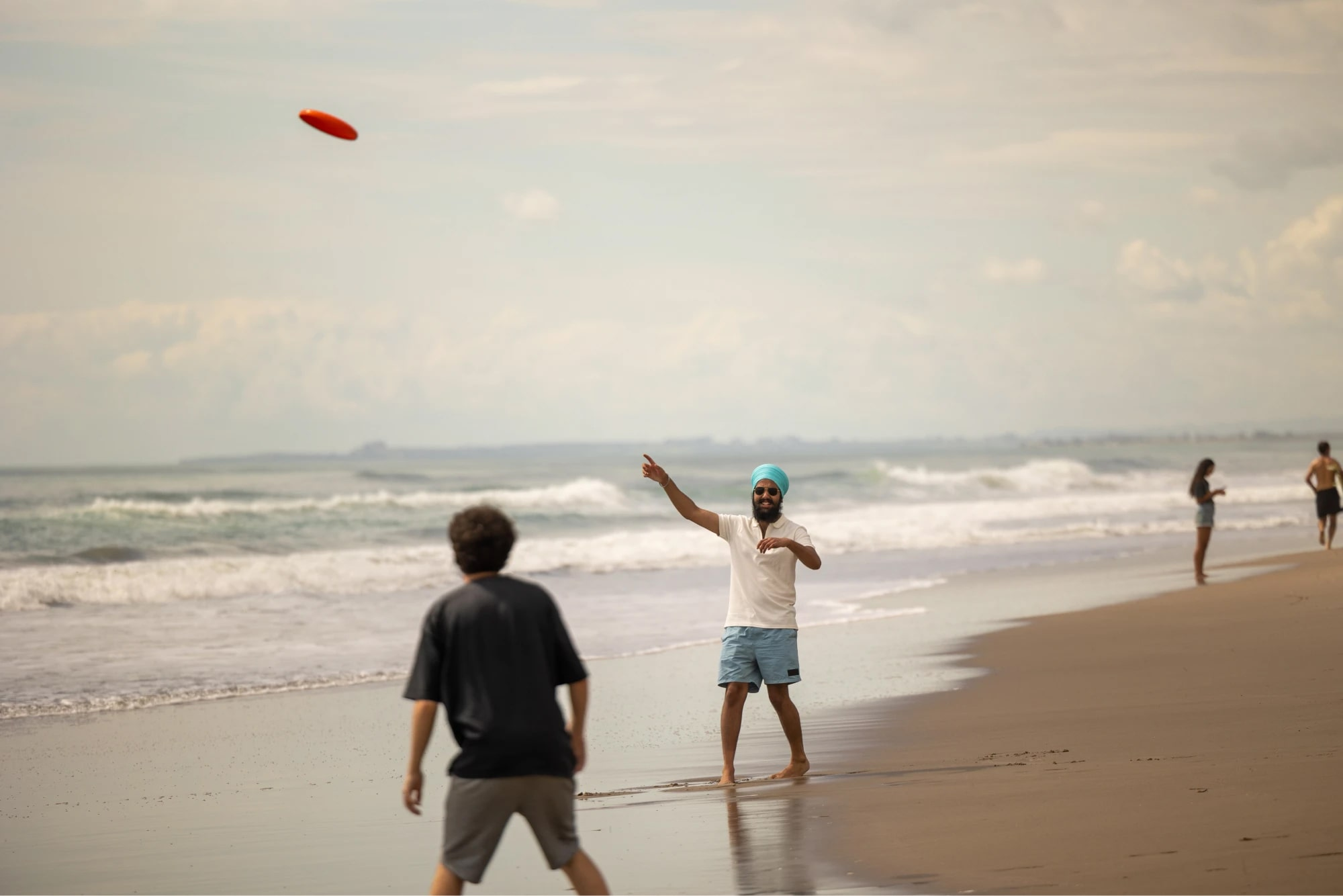 students-playing-frisbee-sunny-beach