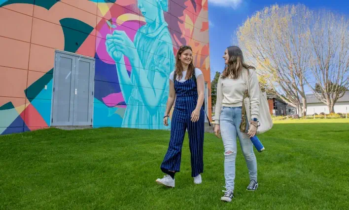 two-students-walking-together-outside